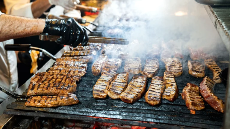 Tablitas meat — grilled flanken short ribs with char marks served with lime and cilantro